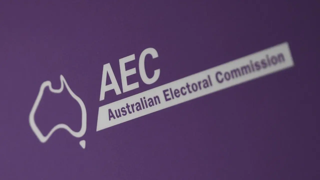 Australian Electoral Commission office with staff assisting visitors with electoral roll inquiries